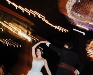 The couple's first dance under string lights, shot by a guest